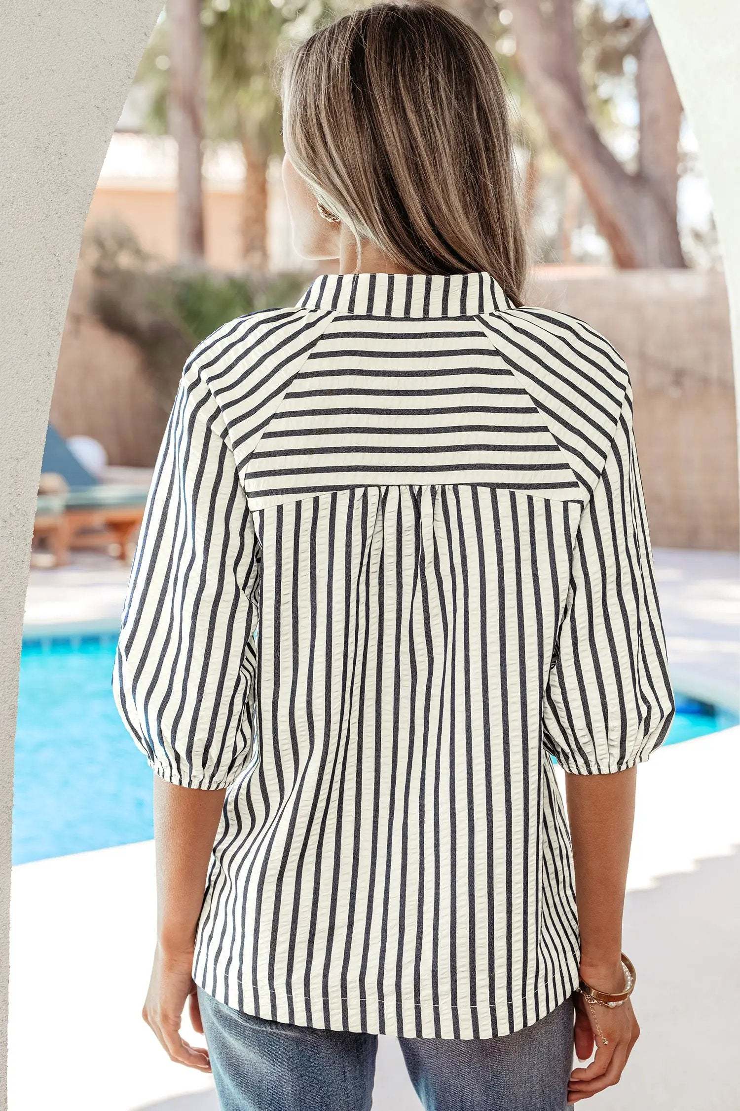 Woman wearing cool mom energy floral embroidered stripe V-neck short sleeve blouse