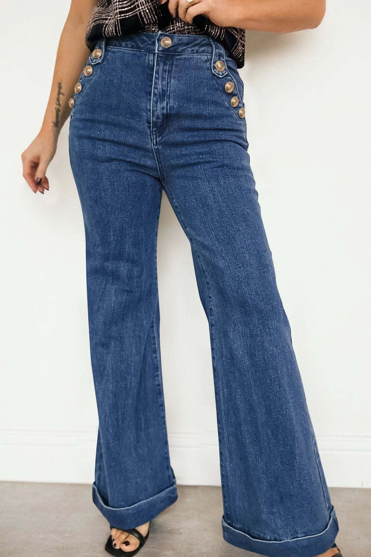 High-rise wide-leg denim jeans with gold button detail and rolled-edge flare leg