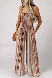 Woman wearing yellow stripe smocked square neck jumpsuit with wide leg outdoors
