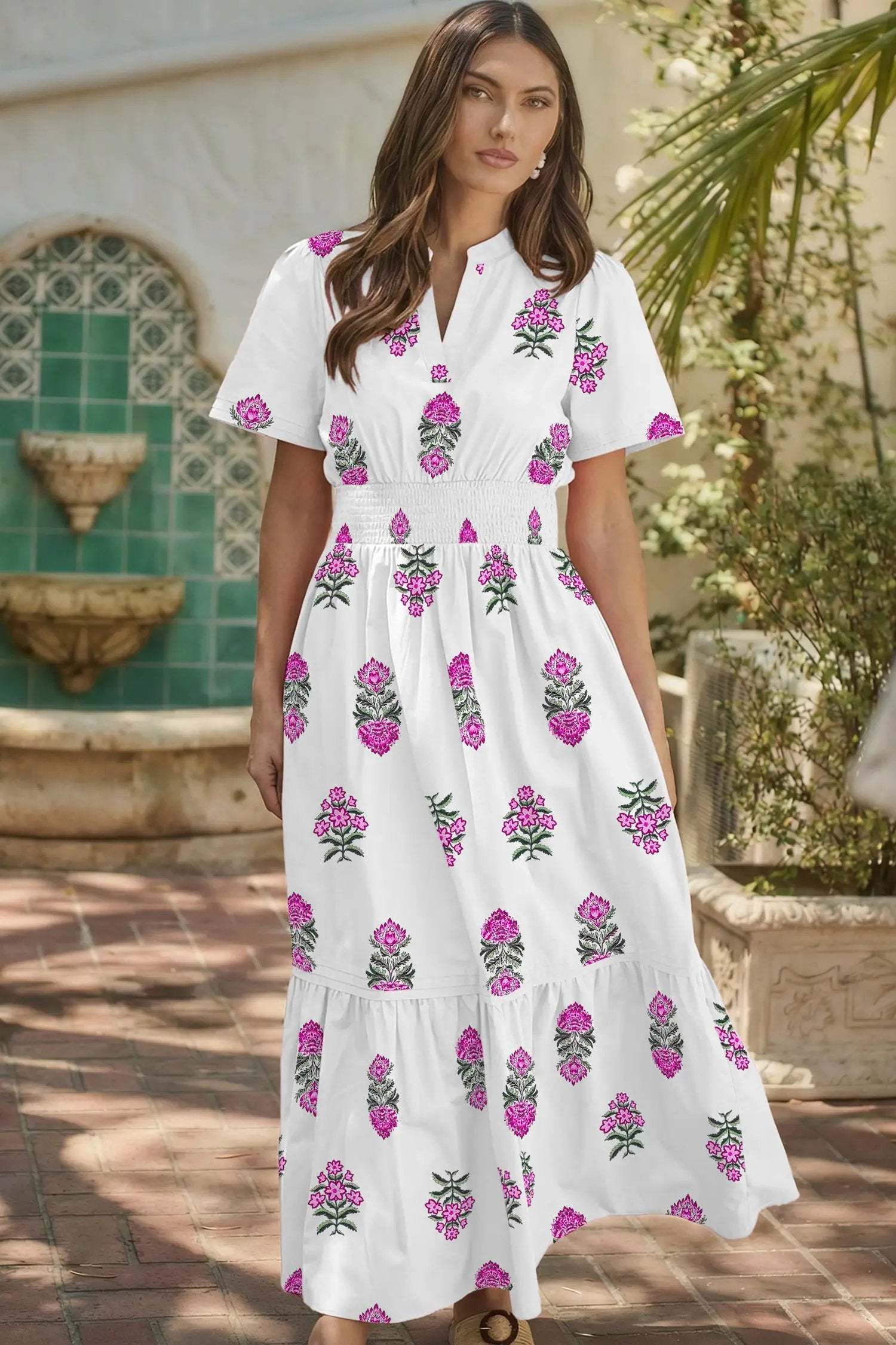 Woman wearing a floral print split neck maxi dress with shirred waist and ruffle hem showcasing main character energy