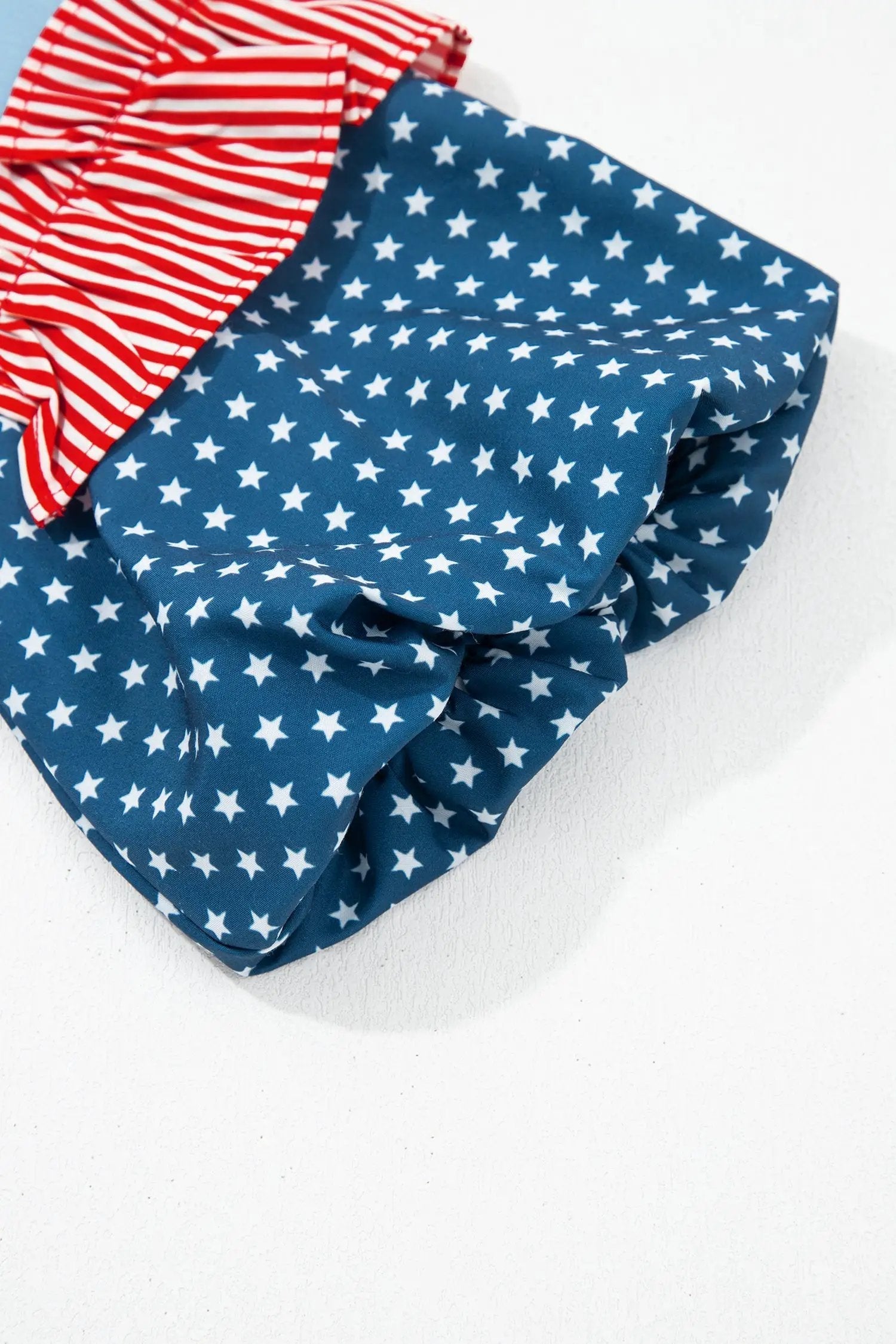 Fiery red stars stripes puff sleeve top with American flag print and sky-blue bodice
