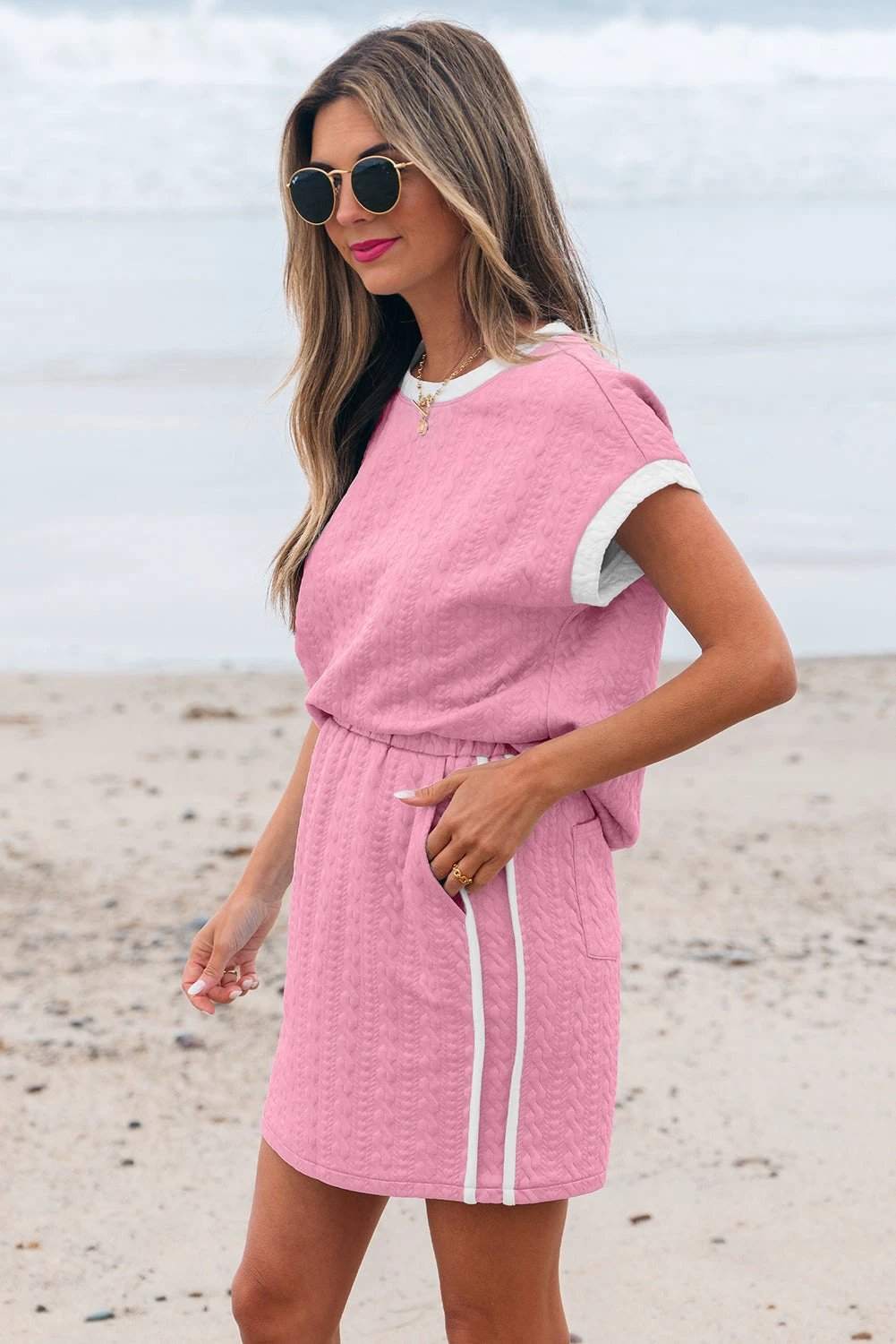 Woman wearing textured crewneck tee with contrast trim and pocketed skirt set