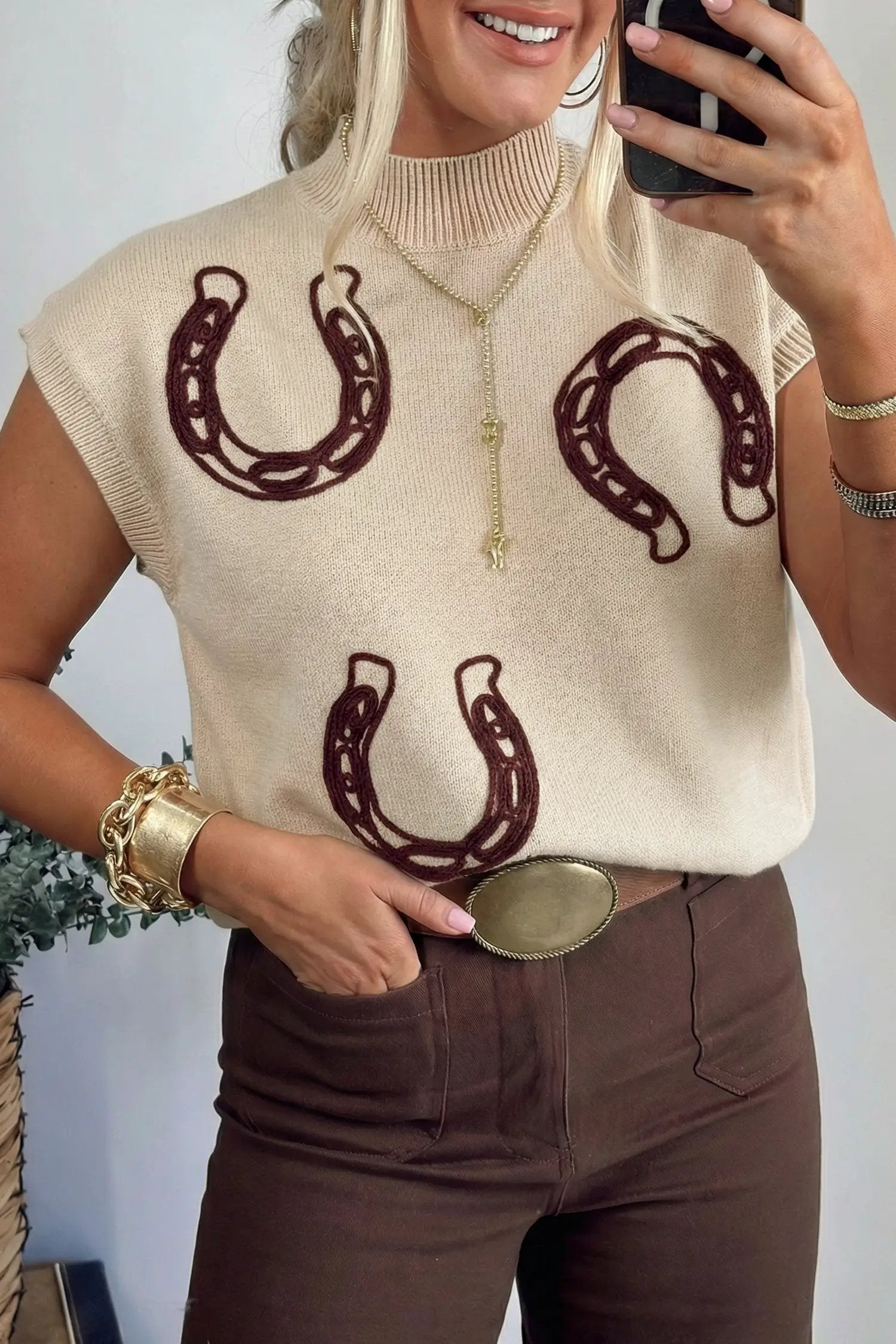 Bright green ribbed mock neck knit sweater with pink horseshoe embroidery and short sleeves