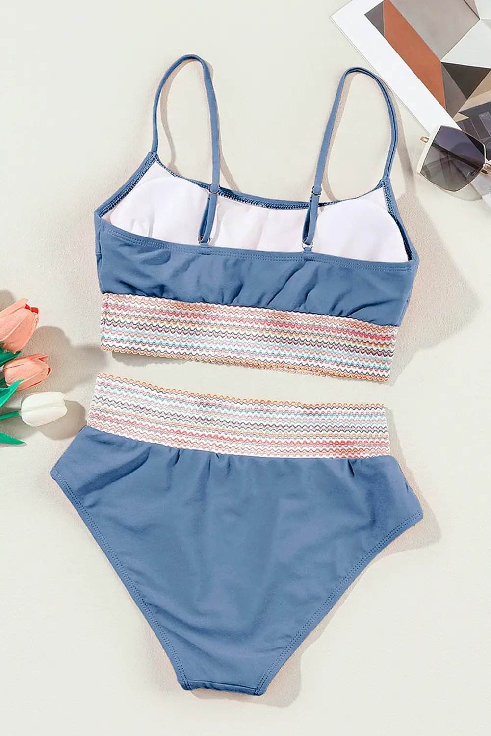 Blue high waist two piece bikini set with colorful stitch border on beach background