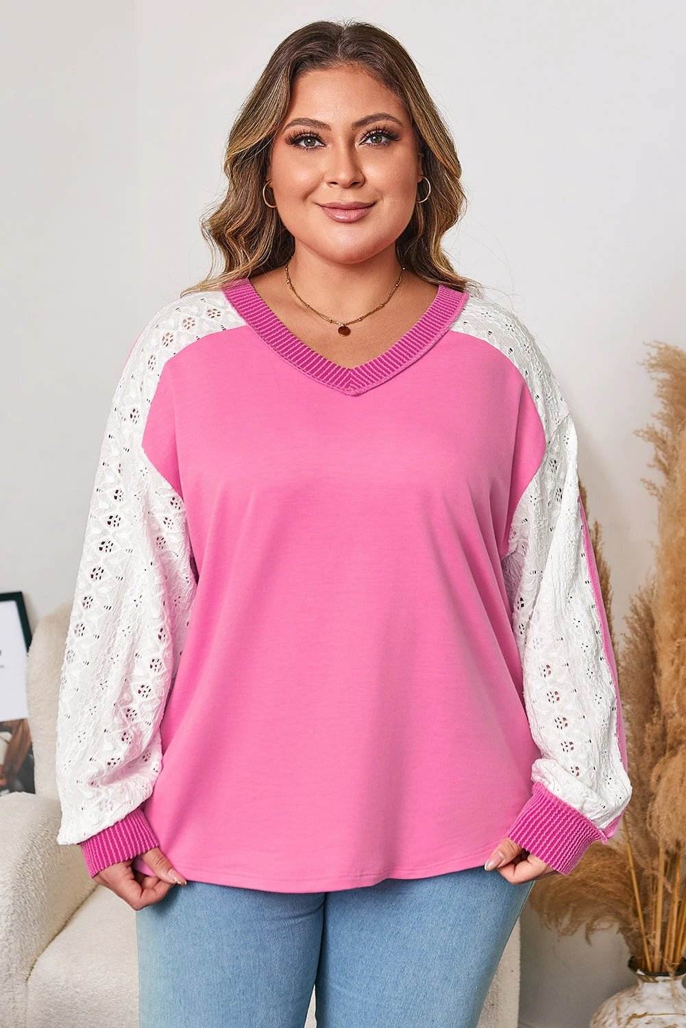 Plus size V-neck top with lace stripe sleeves and corded trim on bust.