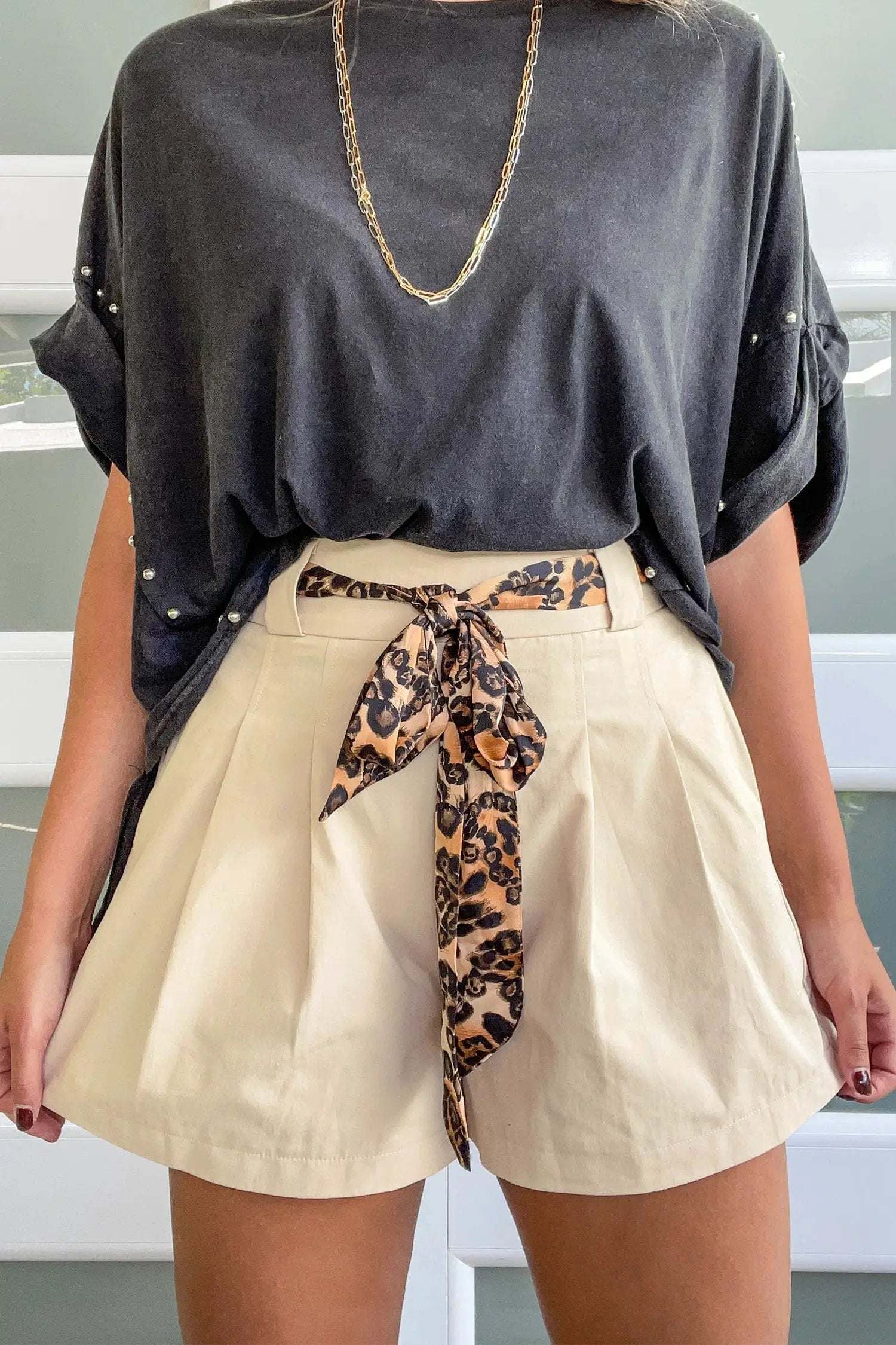 Pink pleated wide-leg shorts with leopard contrast sash belt, breathable cotton-linen blend for a weekend vibe