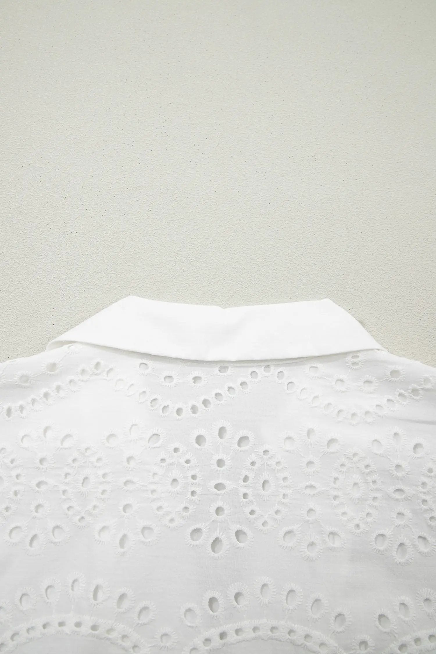 Model wearing white solid color eyelet embroidered T shirt mini dress outdoors