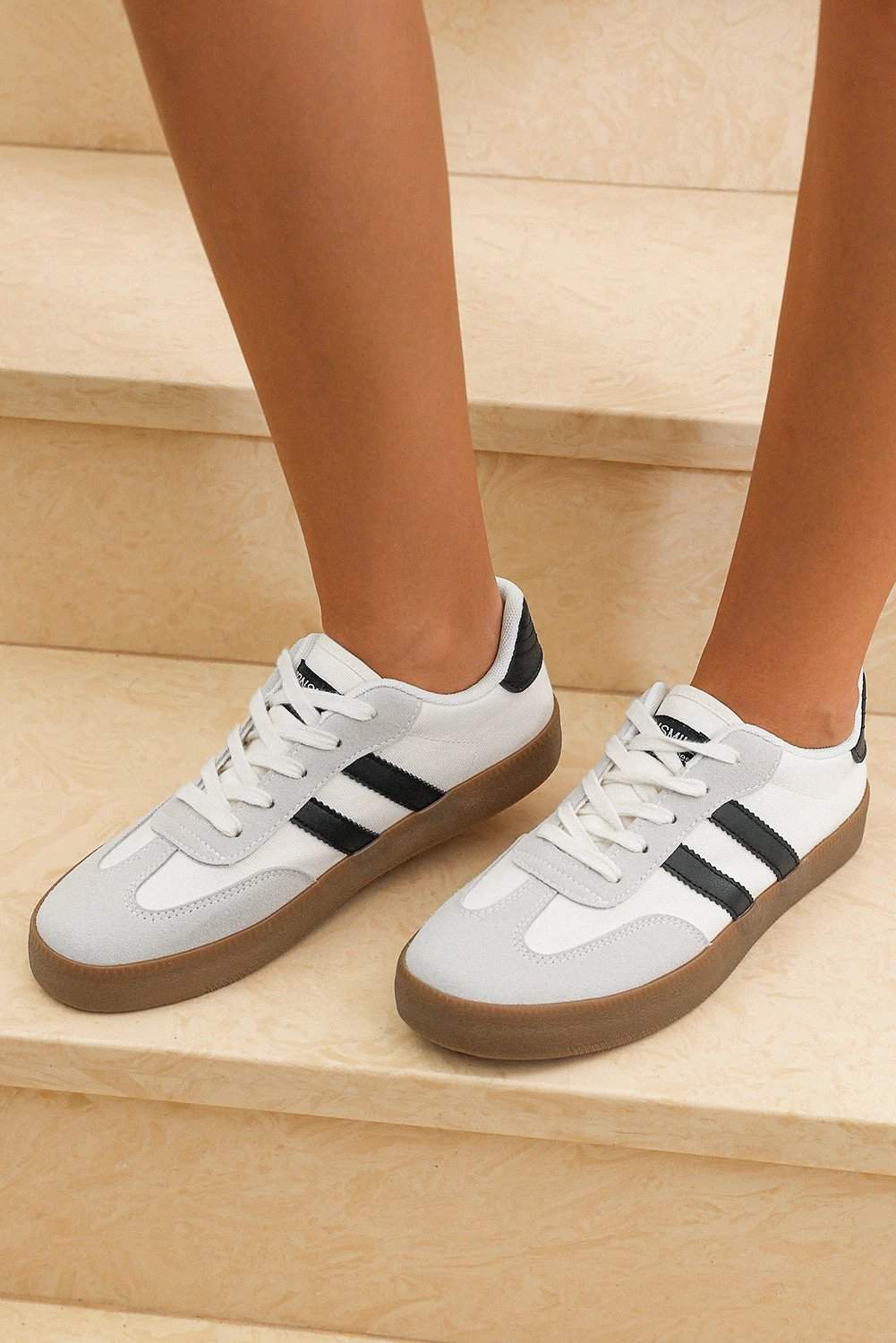 White striped lace-up flat sneakers with gum outsole for chic mom energy style