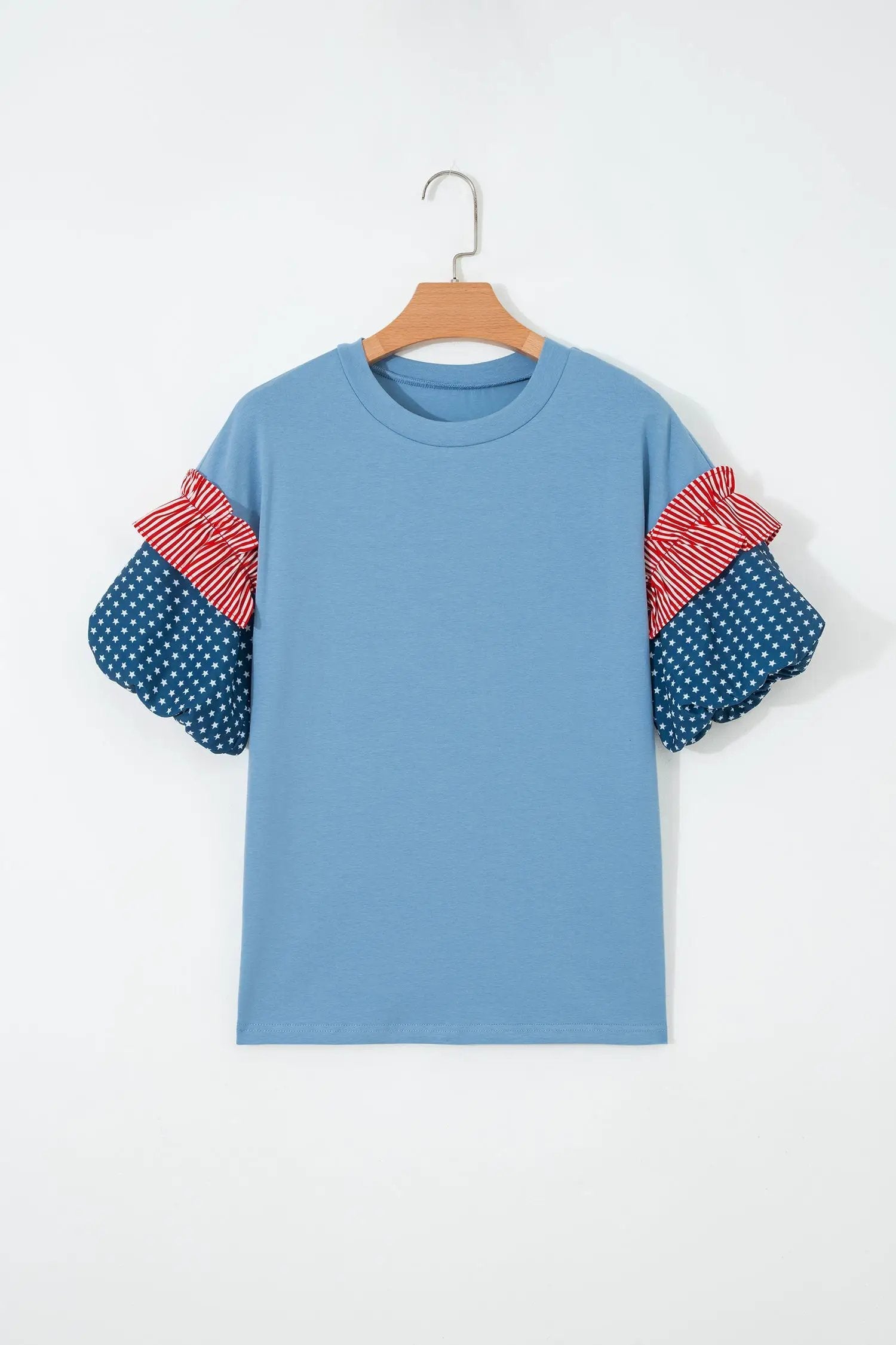 Patriotic puff sleeve top with fiery red stars stripes and American flag print on sky-blue fabric