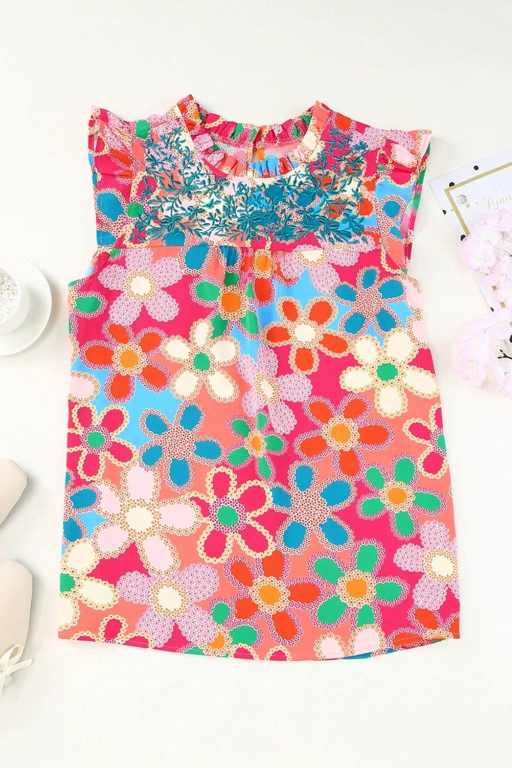 Pink embroidered floral print tank top with ruffle trim and sleeveless design