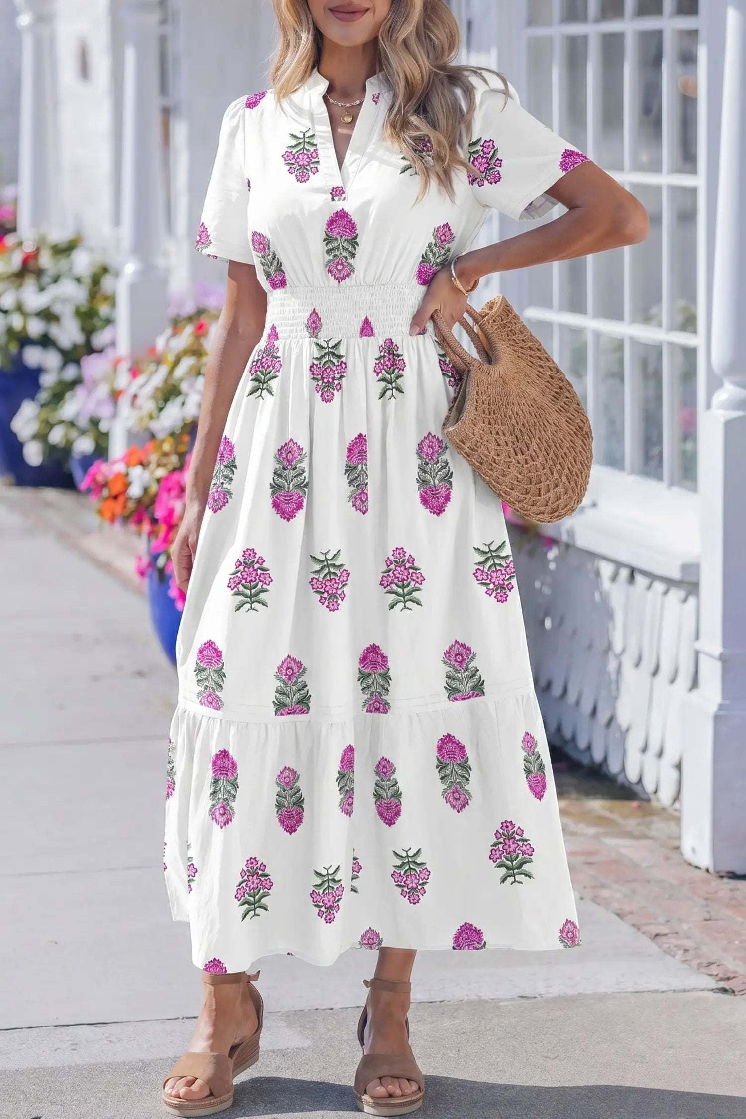 Woman wearing a floral print split neck maxi dress with shirred waist and ruffle hem showcasing main character energy