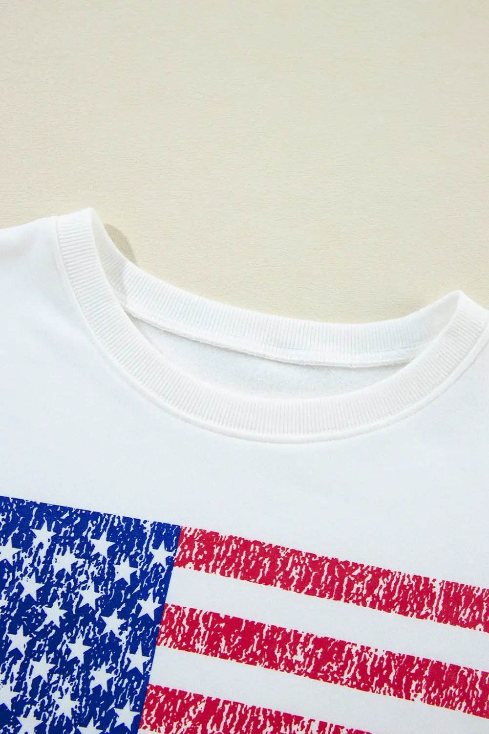 Oversized white American flag graphic sweatshirt with distressed print and drop-shoulder design