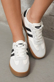 White lace-up sneakers with black stripes, gum outsole, designed for chic mom energy and everyday comfort