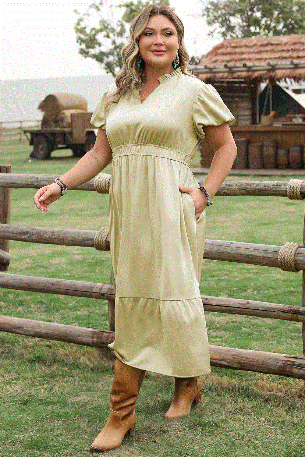 Plus size woman wearing a notched V-neck puff sleeve tiered maxi dress