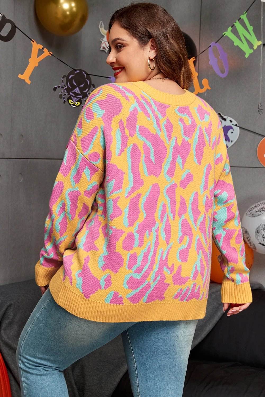 Plus size leopard print ribbed trim cozy sweater on model