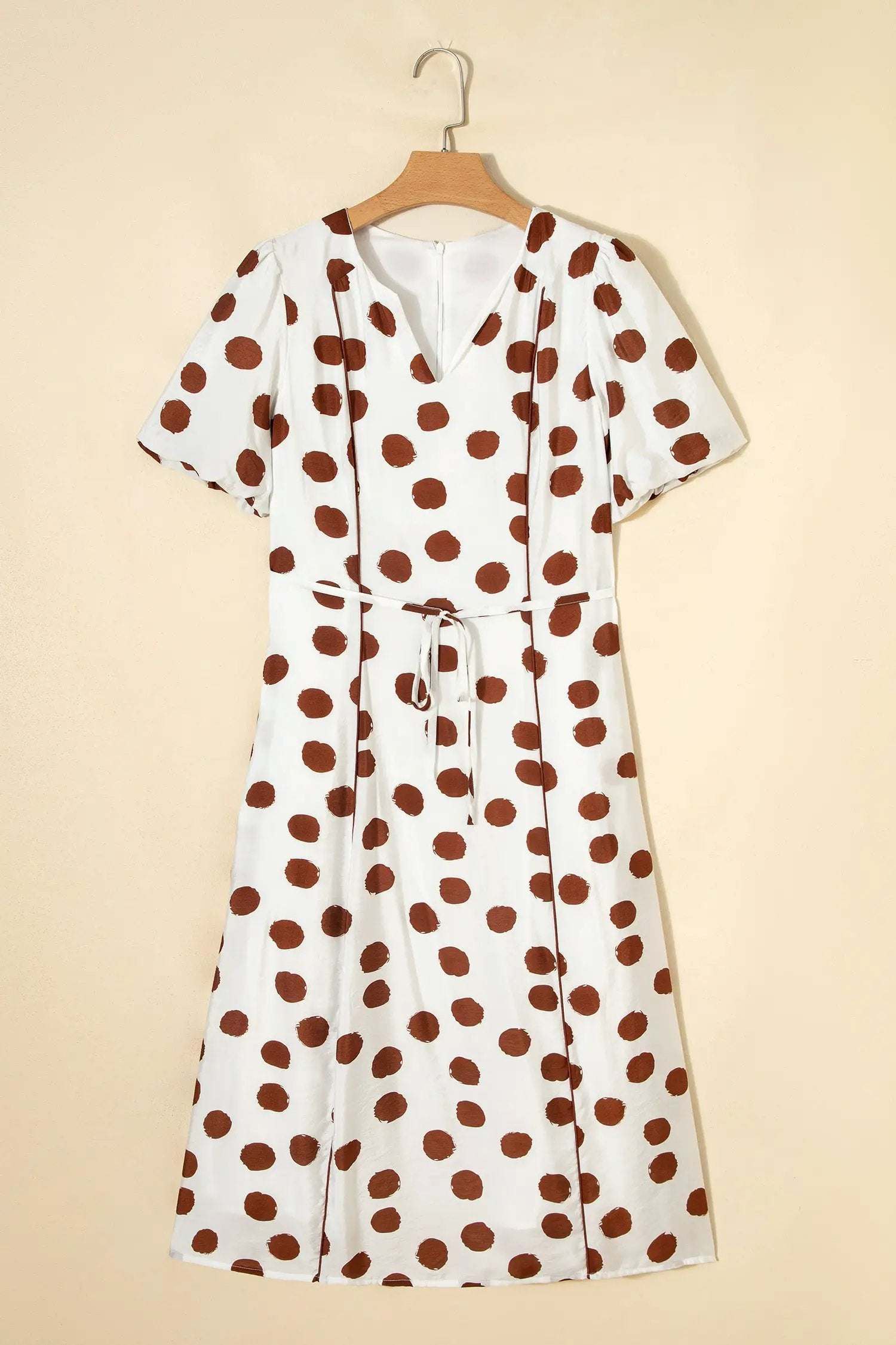 White midi dress with warm brown polka dots, V-neck, short sleeves, and tie waist polka dot daydream dress