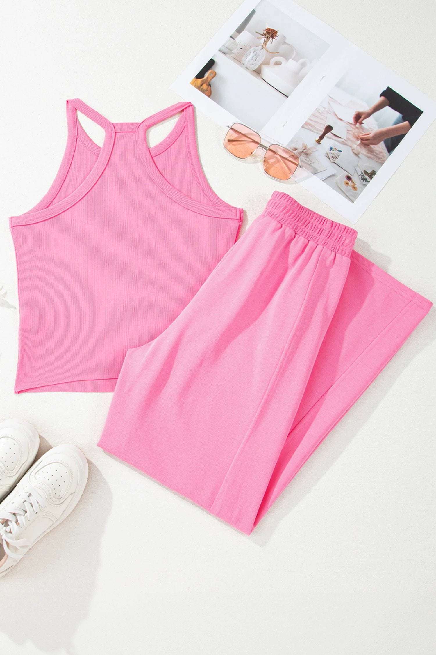 Woman wearing a pink slim ribbed tank top and relaxed wide-leg sweatpants mom energy outfit set