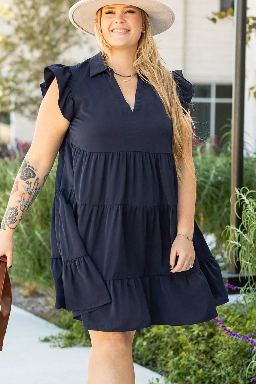 Plus size navy collared V-neck dress with flutter sleeves and tiered skirt