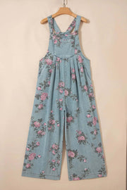 Floral print denim jumpsuit with pleated wide-leg and adjustable straps on model