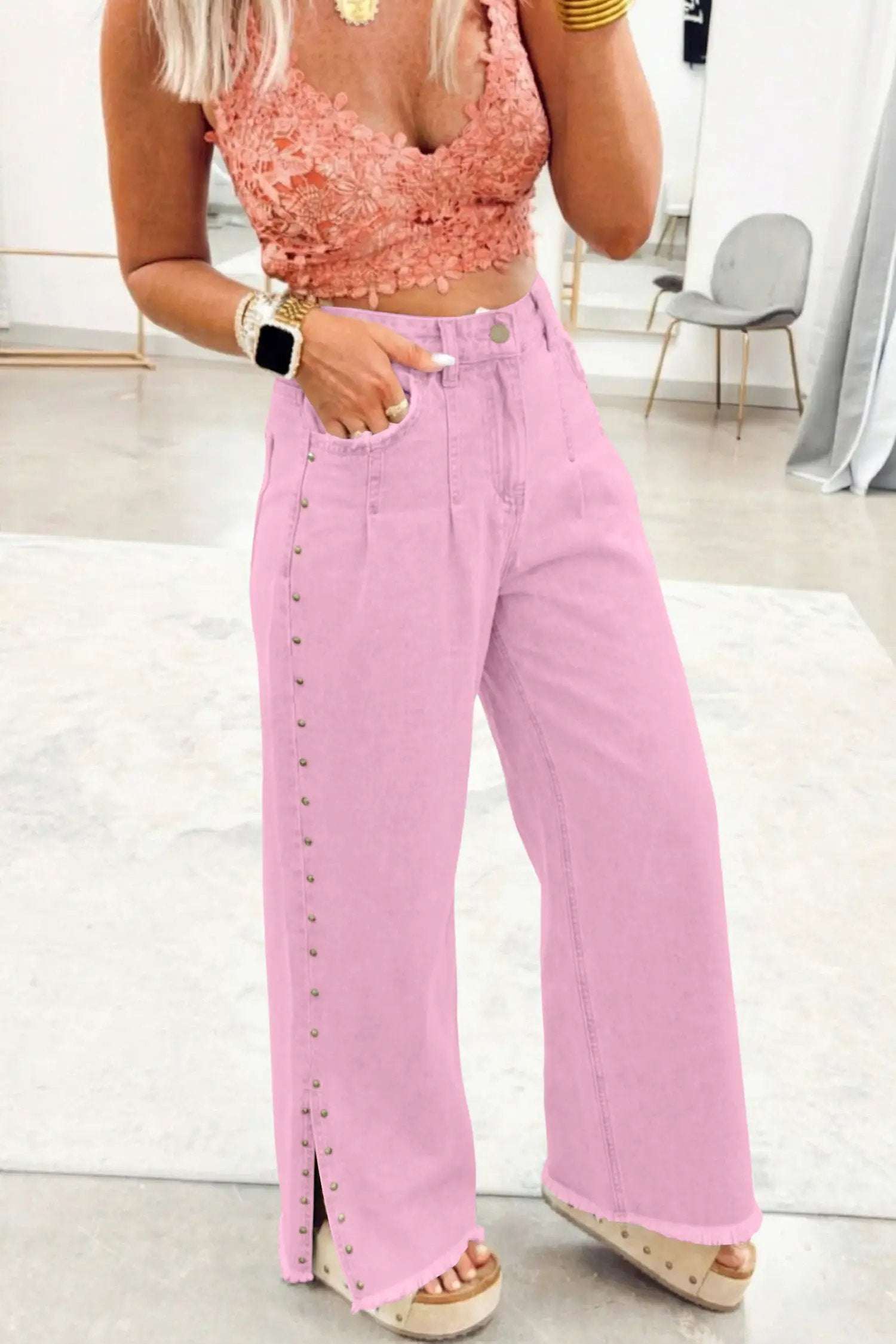 pink high rise wide-leg jeans with beaded side detail and split hem on model