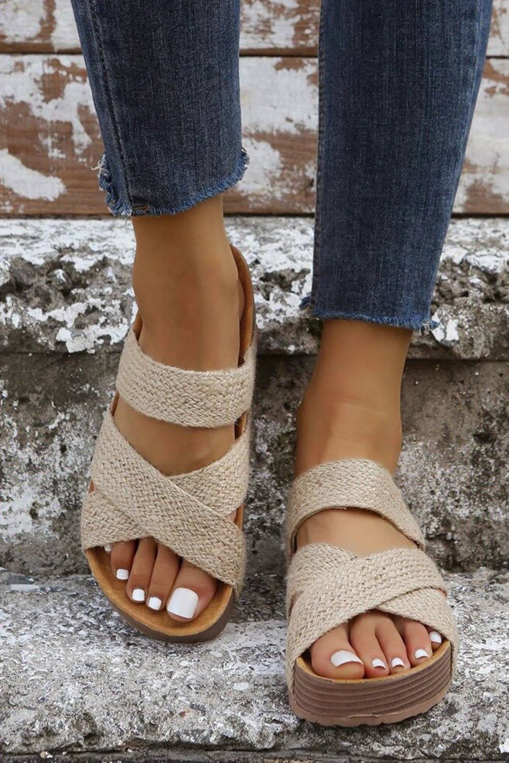 Close-up of neutral woven criss-cross slip-on sandals with hollowed breathable straps and cushioned footbed for everyday comfort