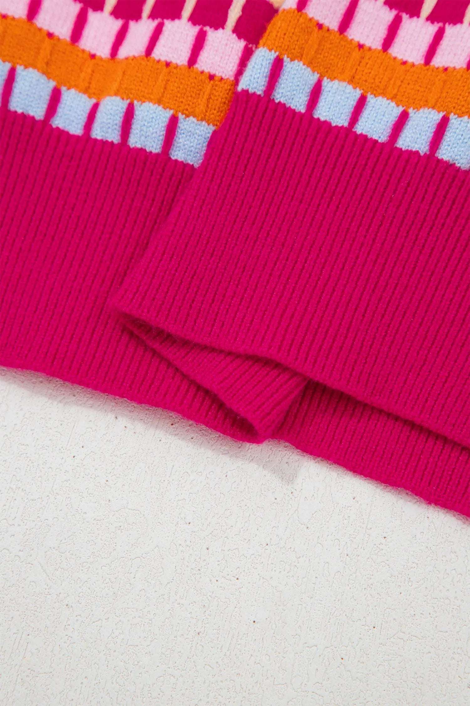 Woman wearing orange striped knit sweater with abstract orange stripes and pink trim