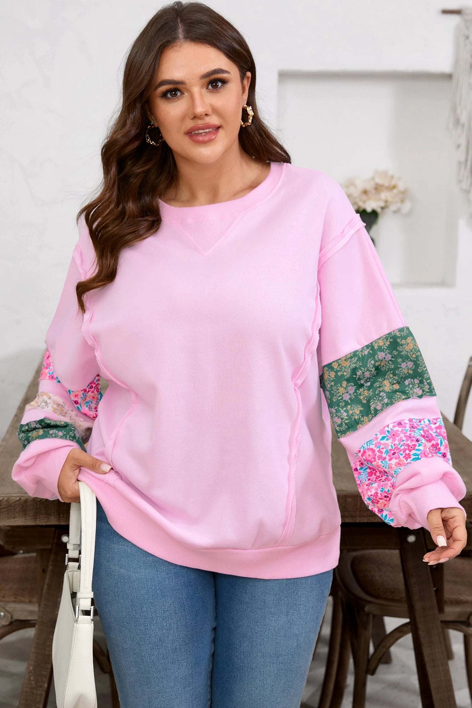 Plus size floral patched sleeve sweatshirt with ribbed trim and relaxed fit
