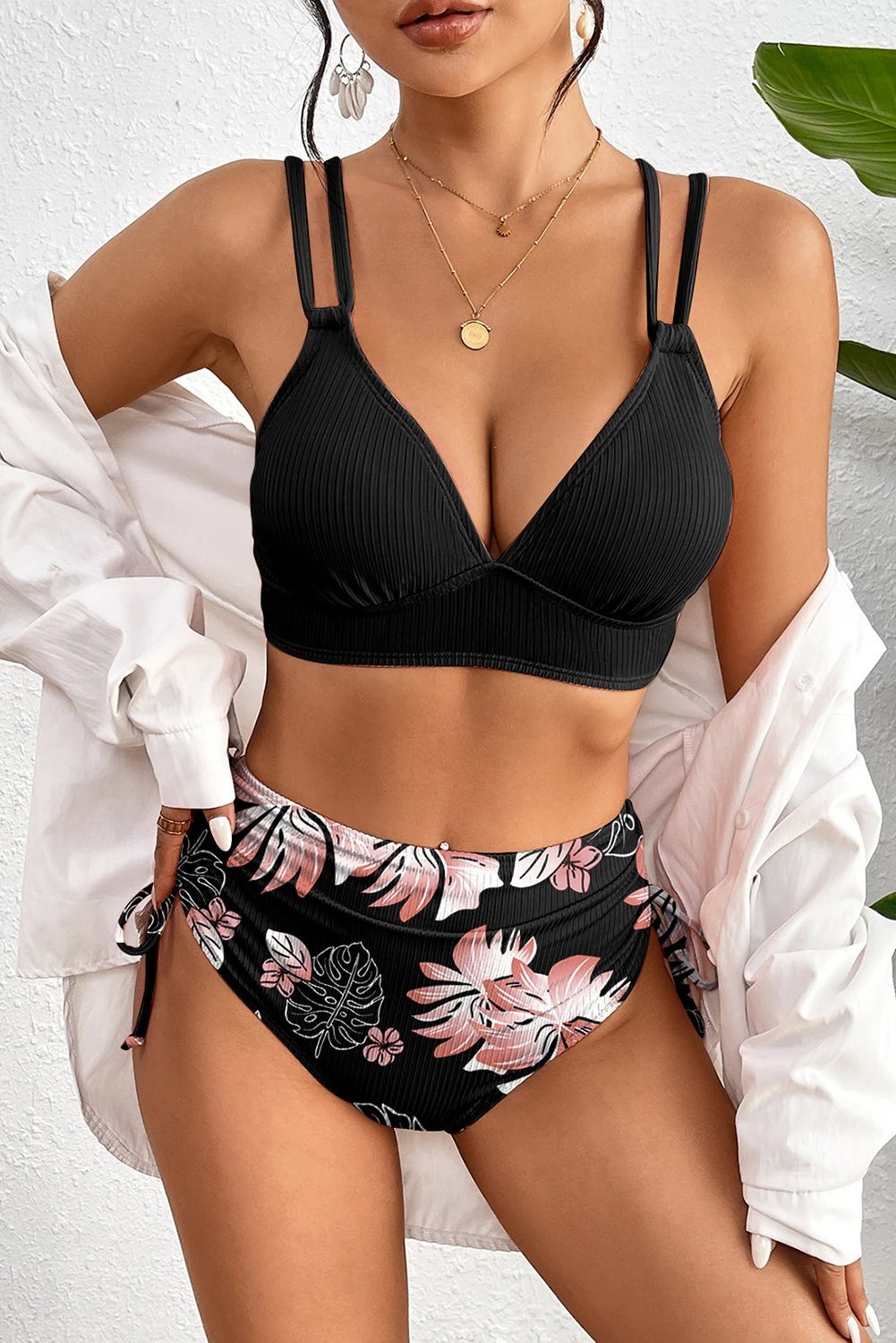 Black ribbed knit high-waist two-piece bikini with floral-print bottom and double-strap top
