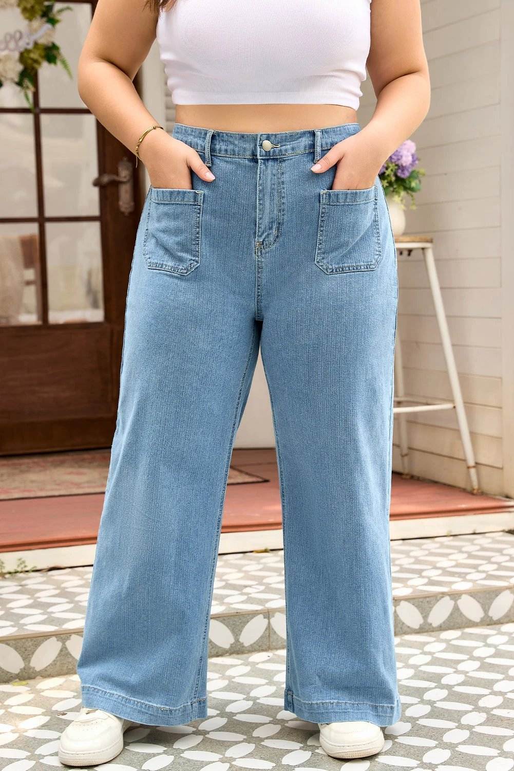 Plus size patch pocket jeans in textured denim with wide leg and mid-to-high rise design