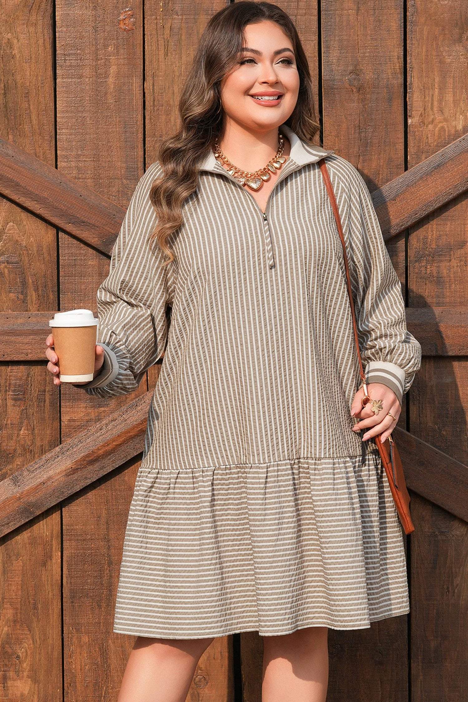 Plus size stripe mini dress with puff sleeves, zip-front collar, and ruffled hem exuding main character energy