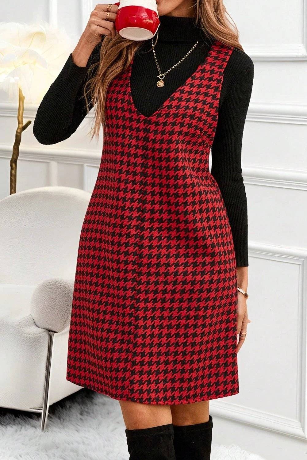 Model wearing red and black houndstooth print V-neck sleeveless mini dress showcasing Main Character Energy style