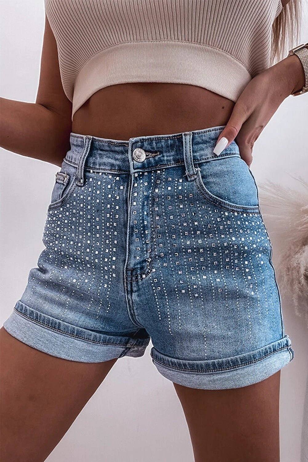 High-rise Summer Spark rhinestone embellished denim shorts with rolled cuff and Western flair on model