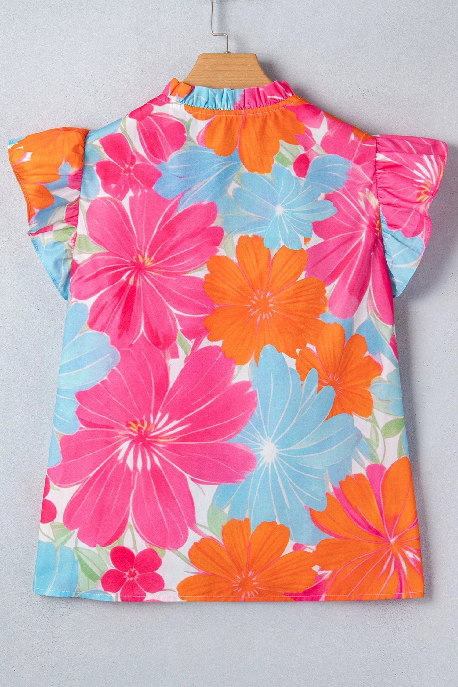 Multicolor floral tie-neck sleeveless blouse with ruffle trim and vibrant flower print