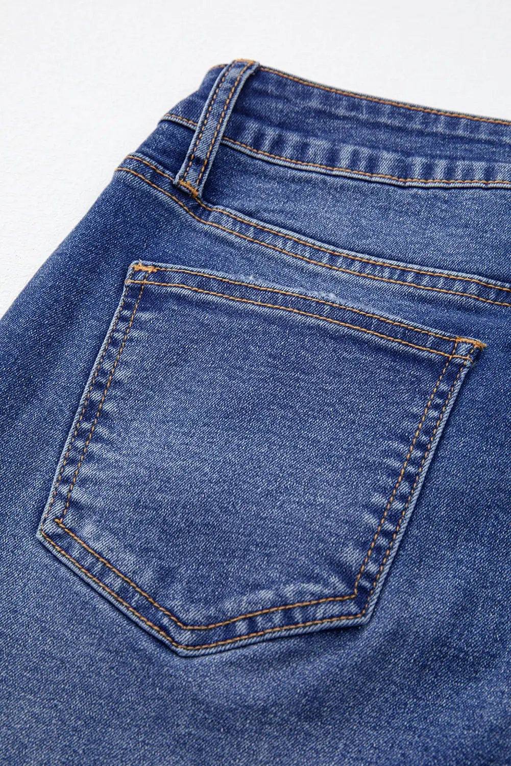 Woman wearing whiskered wash cropped jeans with raw hem showcasing main character energy style