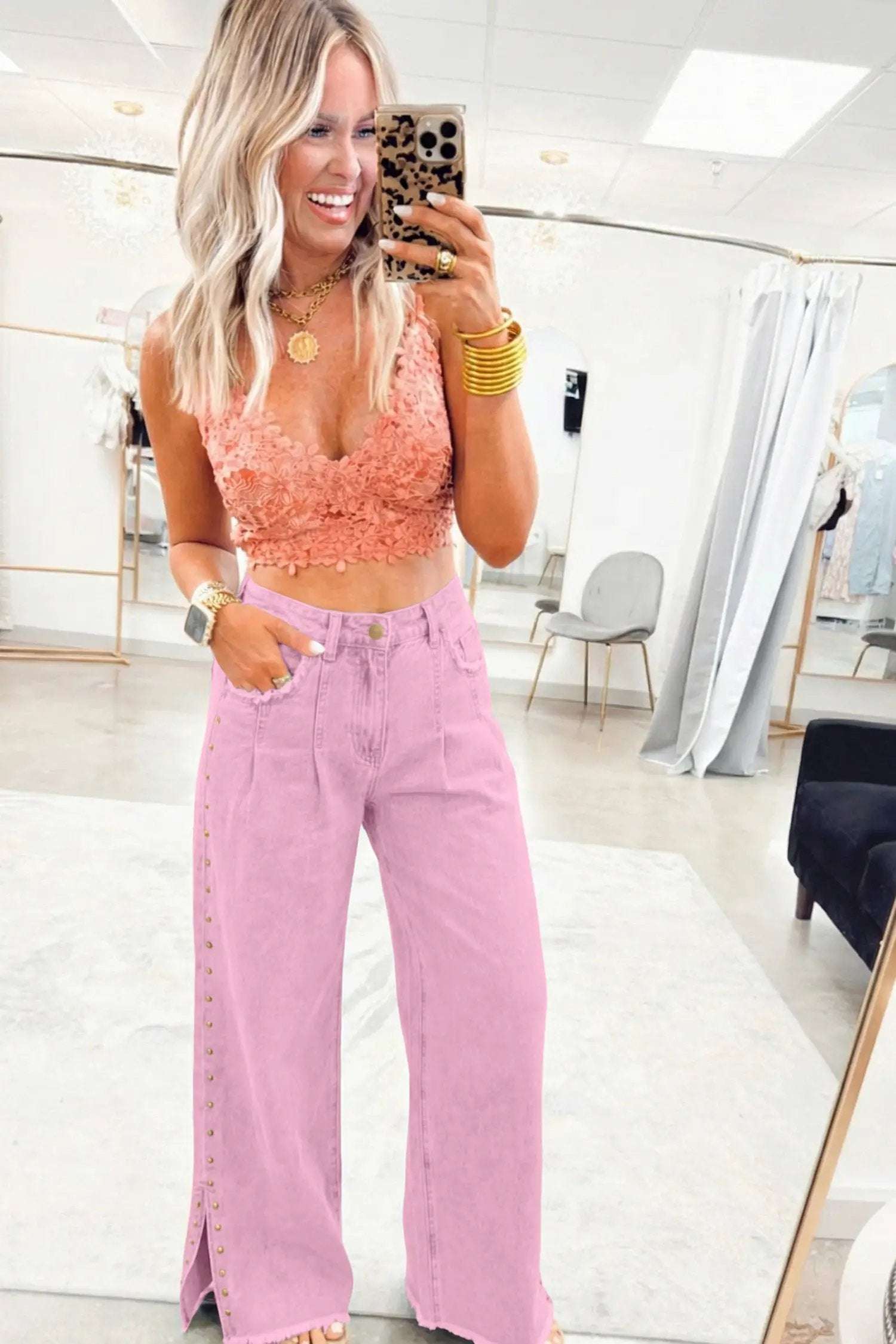 Pink high rise wide-leg jeans with beaded side detail and split hem on model