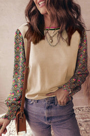 Woman wearing floral patchwork sleeves sweater with shirred cuff puff sleeves and neutral body