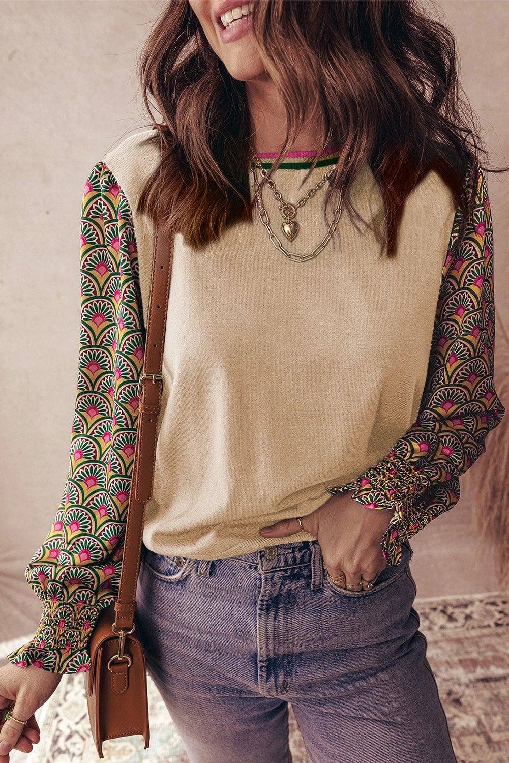 Woman wearing floral patchwork sleeves sweater with shirred cuff puff sleeves and neutral body