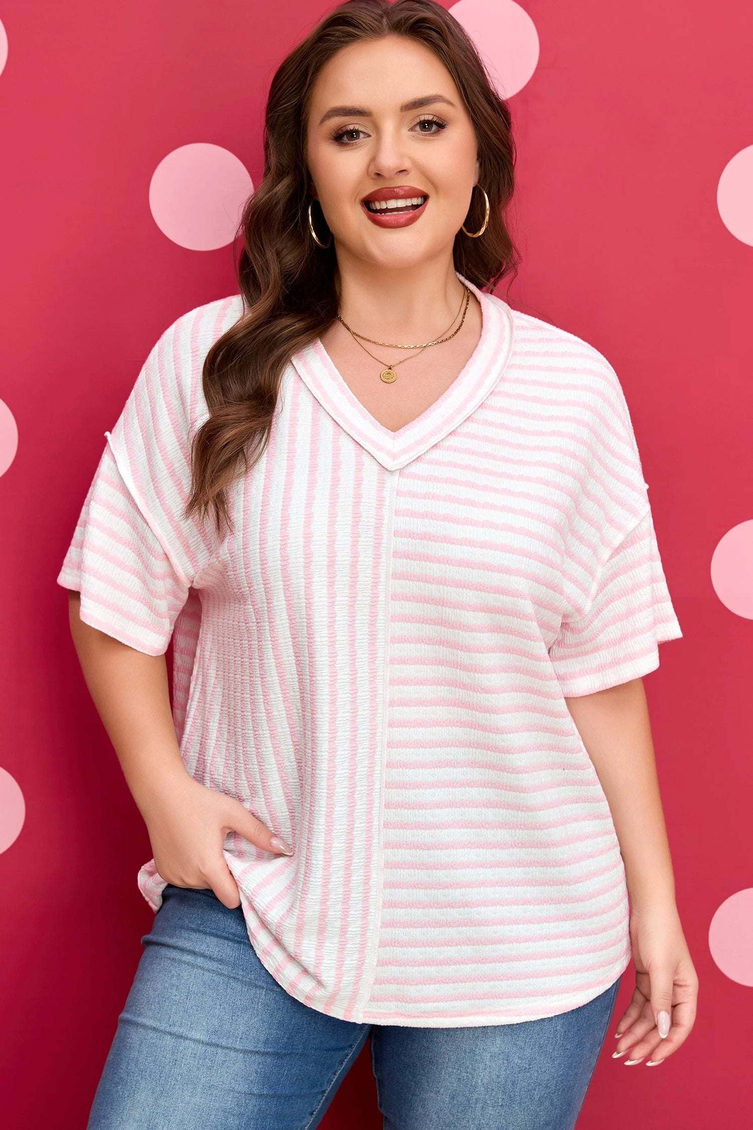 Plus size pink stripe V-neck tee with exposed seam detailing and relaxed fit