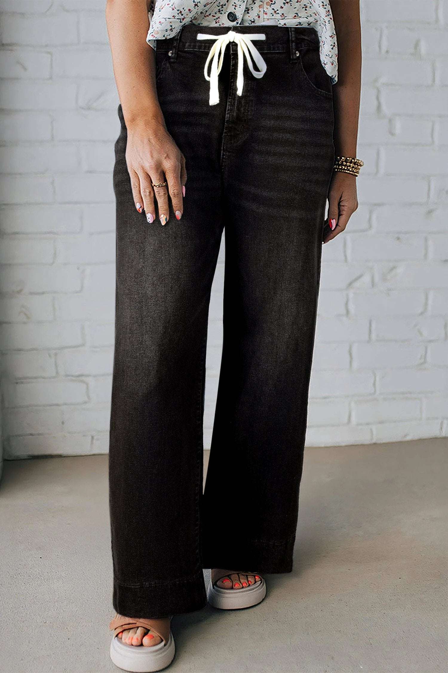 Plus size acid wash high rise wide leg jeans with lace-up waist showcasing main character energy style