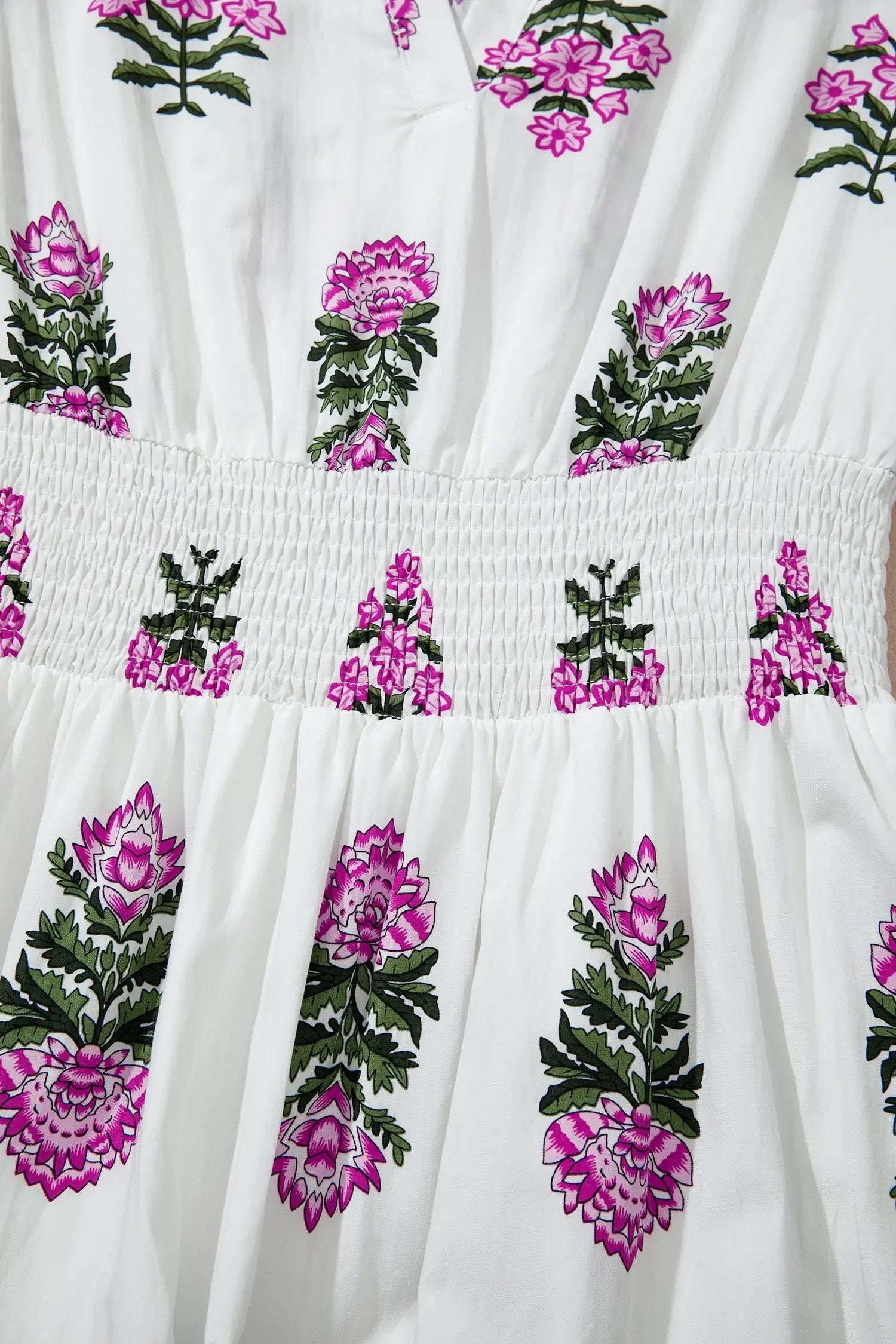 Woman wearing a floral print split neck maxi dress with shirred waist and ruffle hem embodying main character energy