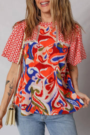 Woman wearing effortless boho chic paisley geometric puff sleeve blouse top
