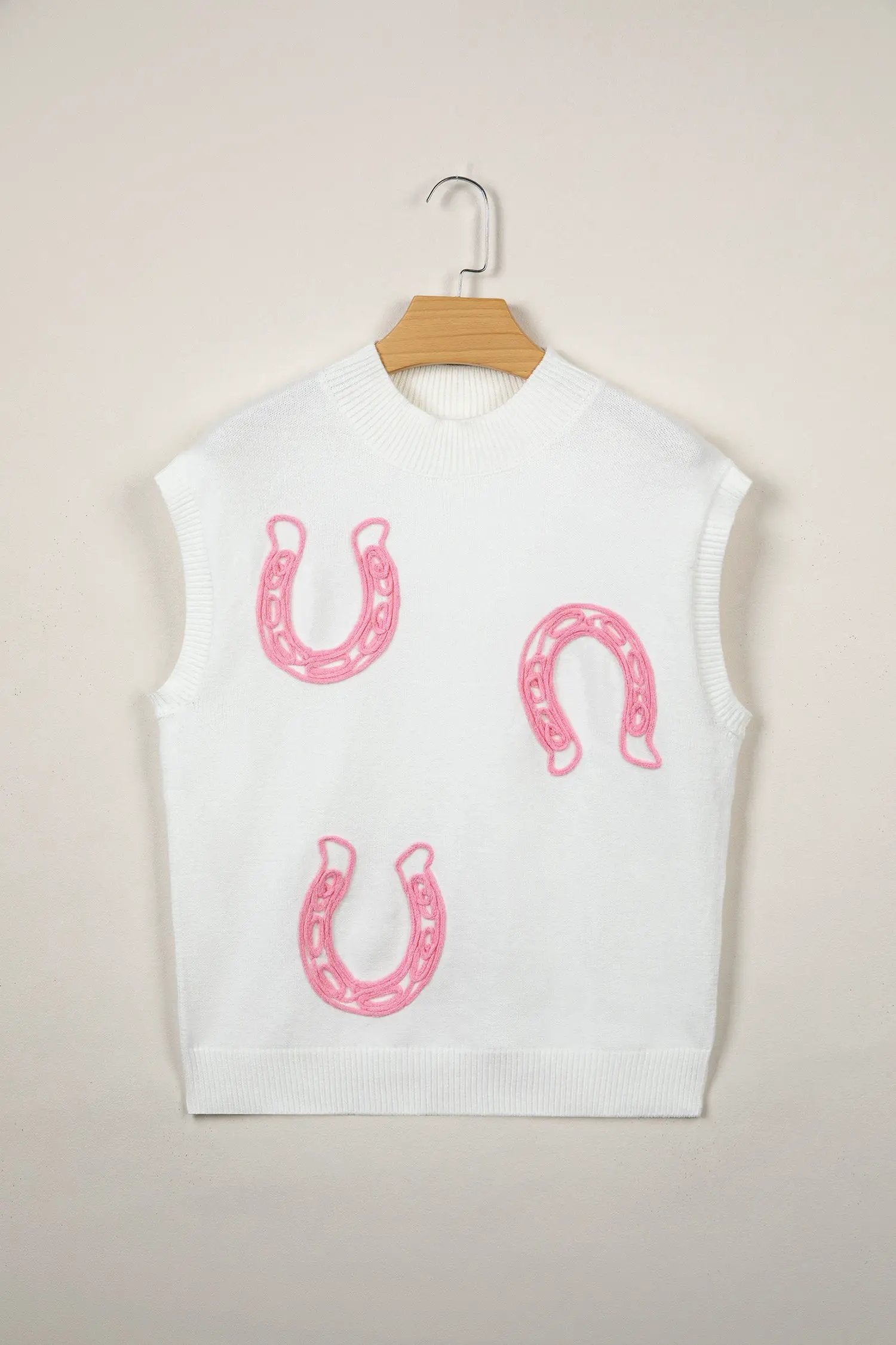 Bright green ribbed mock neck short sleeve knit sweater with pink horseshoe embroidery.