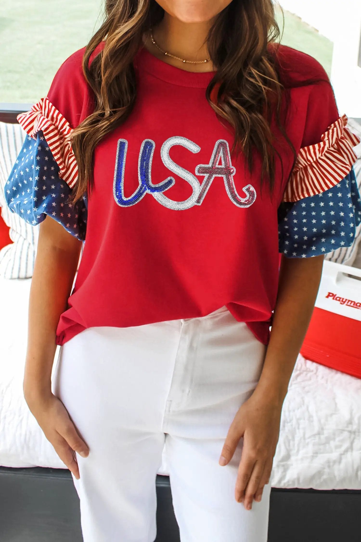 Woman wearing fiery red sequin USA graphic tee with contrast star-spliced sleeves