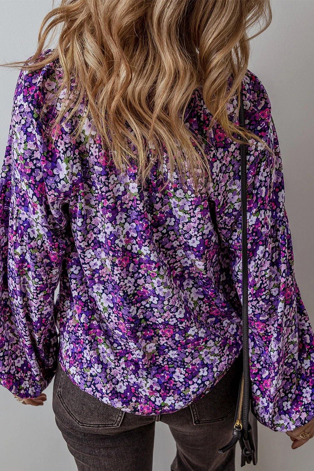 Purple floral Boho Bloom blouse with split V-neck and bubble sleeves.