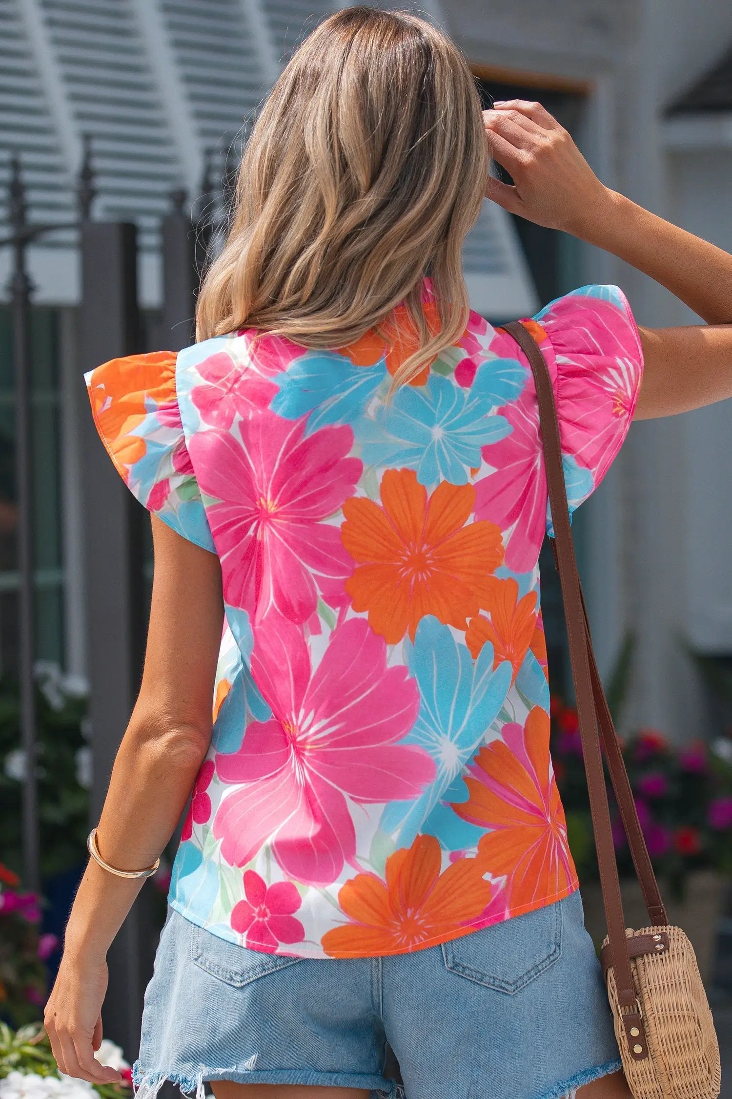 Multicolor floral tie-neck sleeveless blouse with ruffle trim for vacation vibes