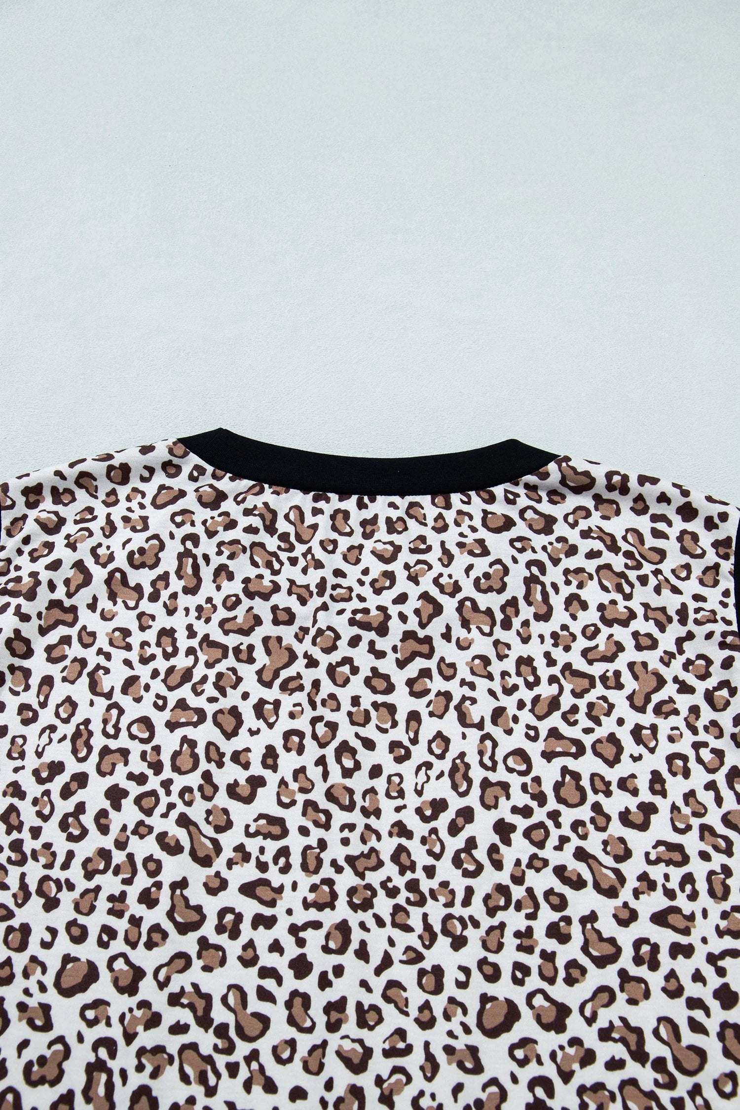 Plus size leopard top with khaki contrast trim, sleeveless and relaxed fit
