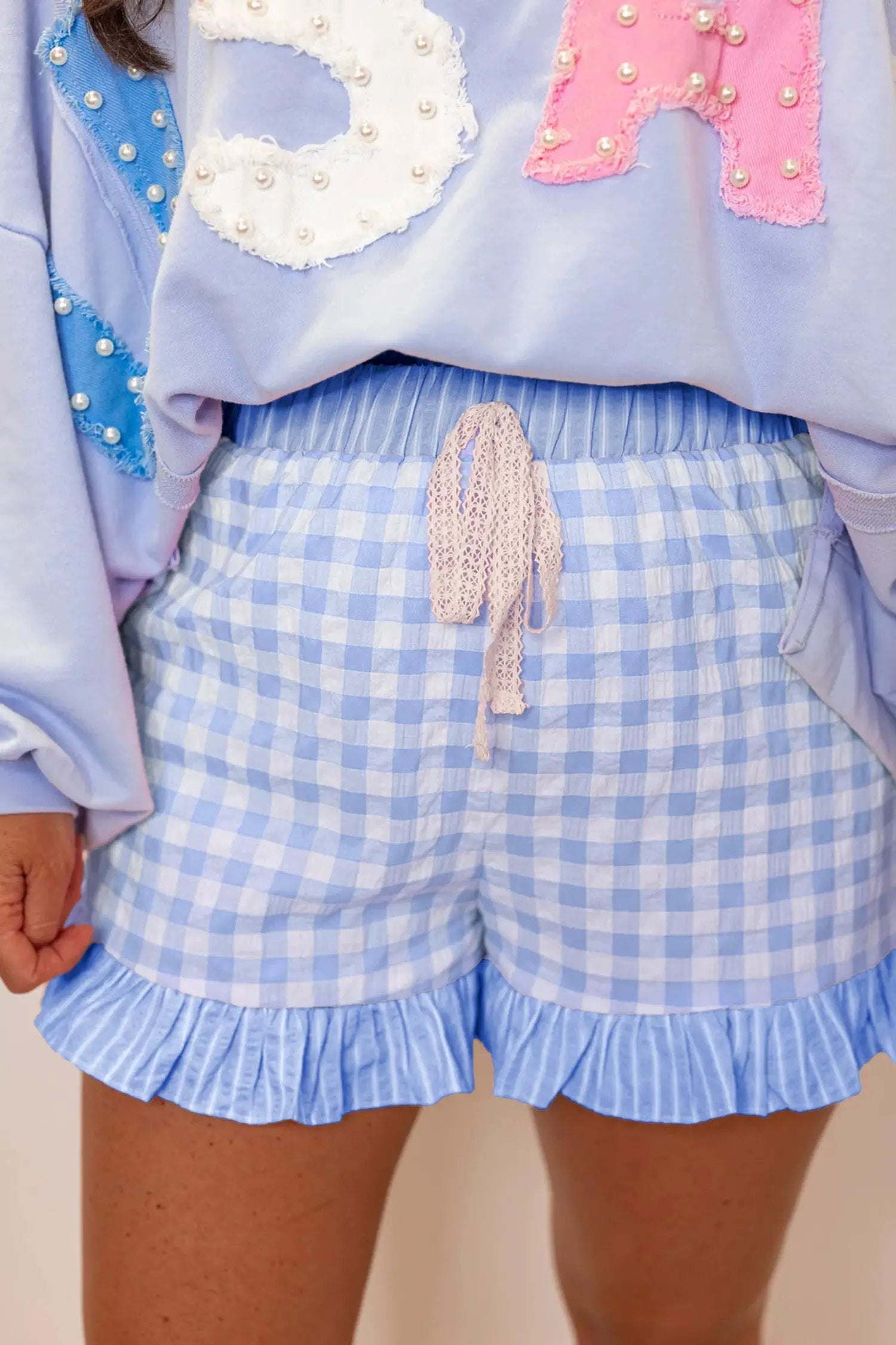 Gingham ruffle hem shorts with lace tie waist in lightweight breathable fabric