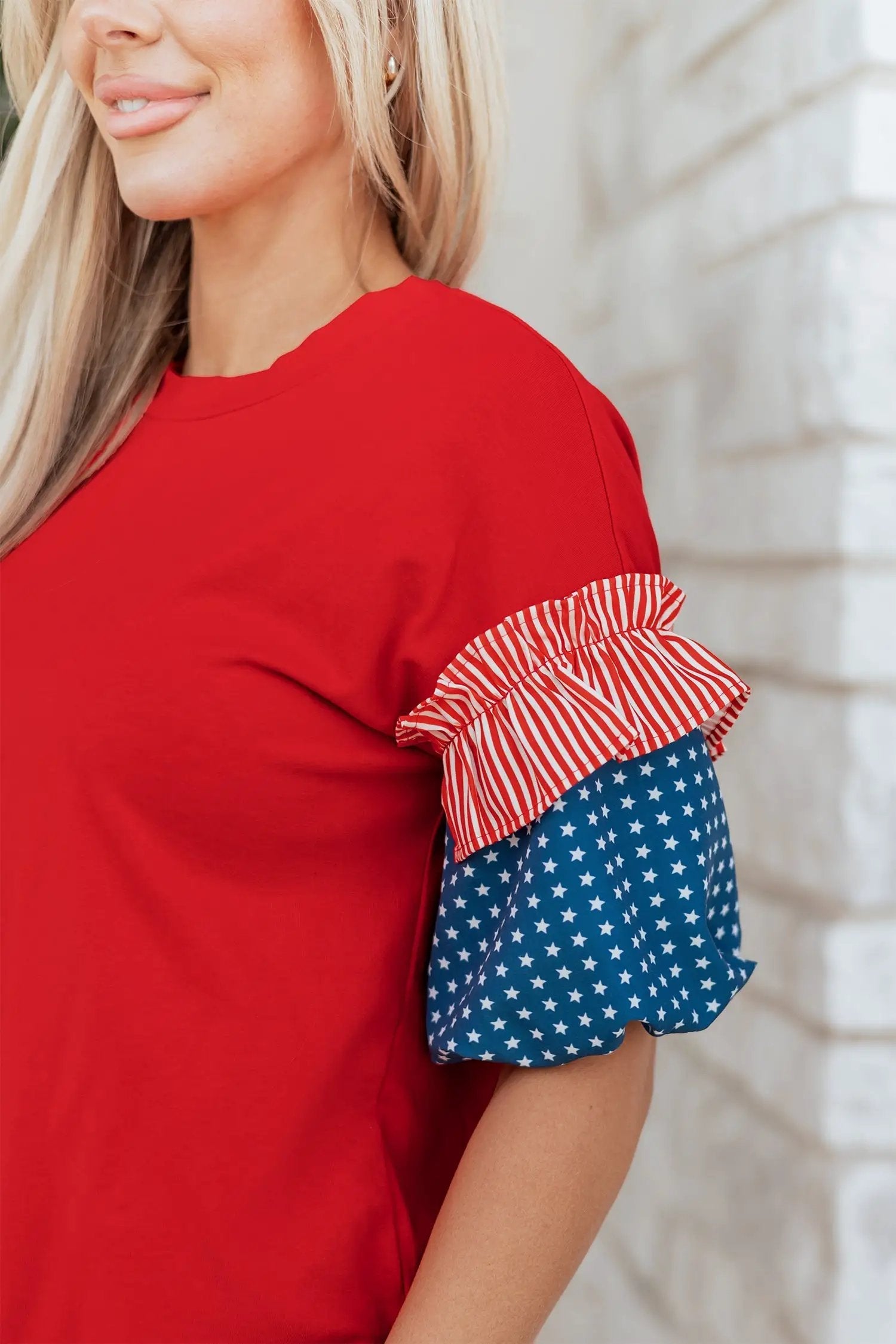 Patriotic puff sleeve top with fiery red stars stripes and American flag print on sky-blue fabric