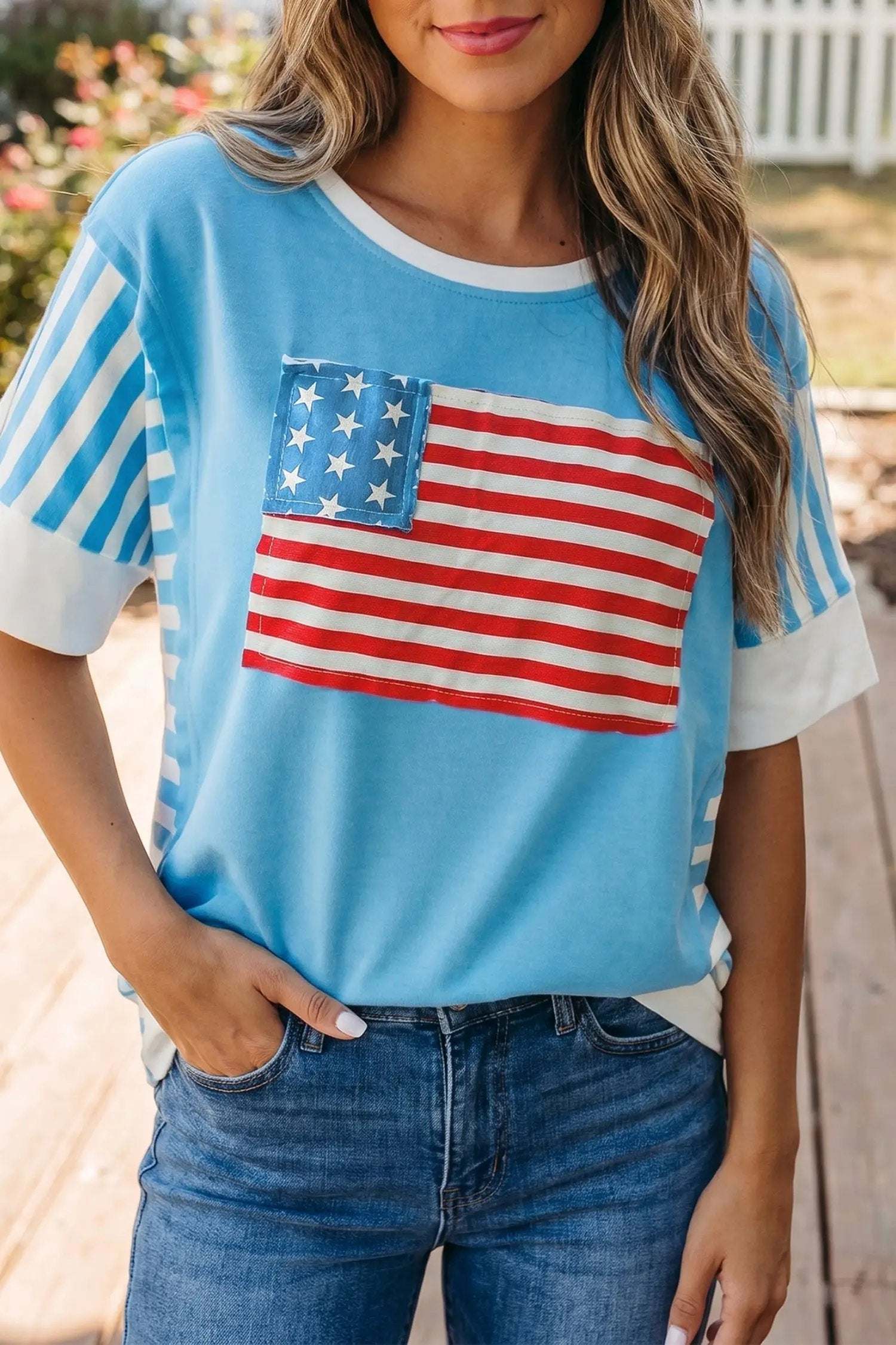 Woman wearing patchwork US flag t-shirt with colorblock sleeves and starry chest panel