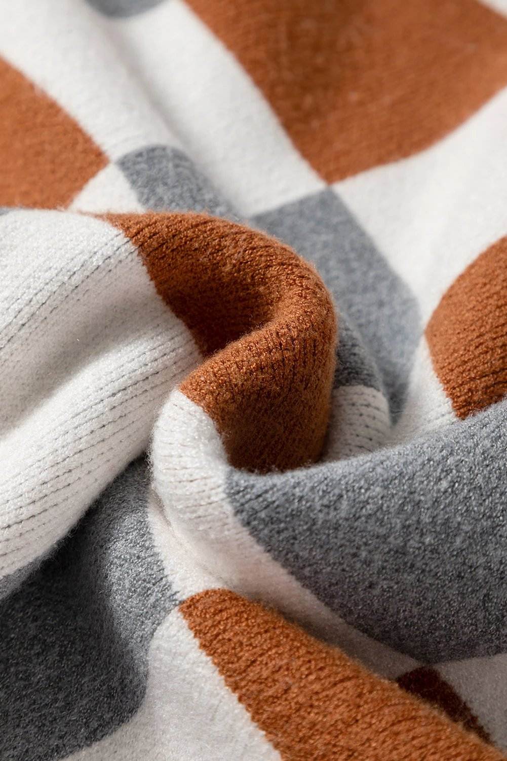 Plus size checkered crewneck sweater in brown, white, and gray with ribbed cuffs and hem, styled casually for effortless warmth and comfort.
